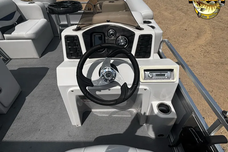 Slide: The Image of 2015 Qwest Adventure 7518 Sport Cruise boat dashboard with steering wheel and controls. - 9