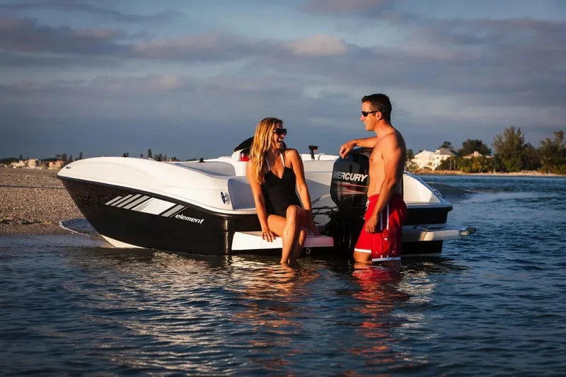 Slide: The Image of Couple enjoying a day by the 2027 Bayliner 160 Element boat on the water. - 8