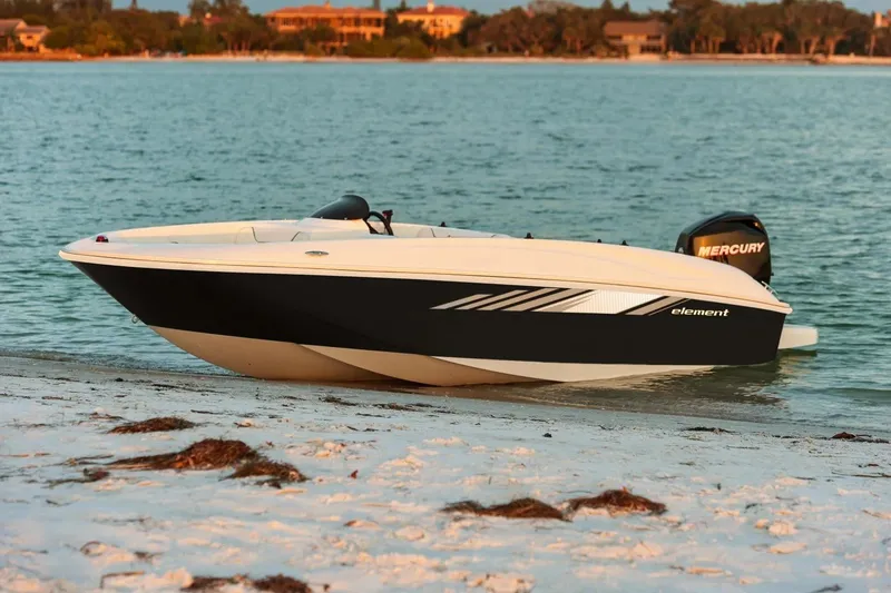 The Image of 2027 Bayliner 160 Element boat on sandy beach by the water. - 1