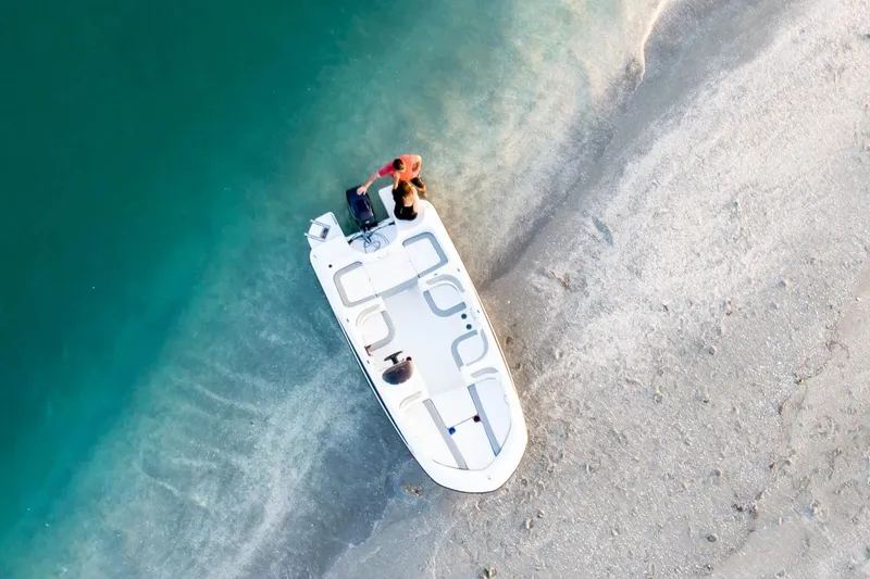 Slide: The Image of Aerial view of 2027 Bayliner 160 Element boat on sandy shore. - 6