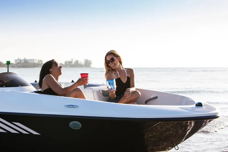 Slide: The Image of Two people relaxing on a 2027 Bayliner 160 Element boat, enjoying the ocean view. - 5