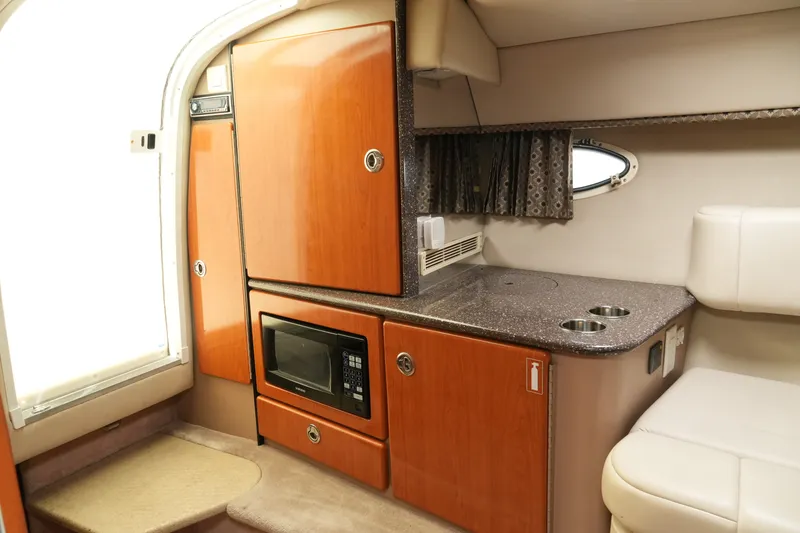 Slide: The Image of Interior of 2004 Formula 330 Sun Sport boat with kitchenette and seating area. - 34