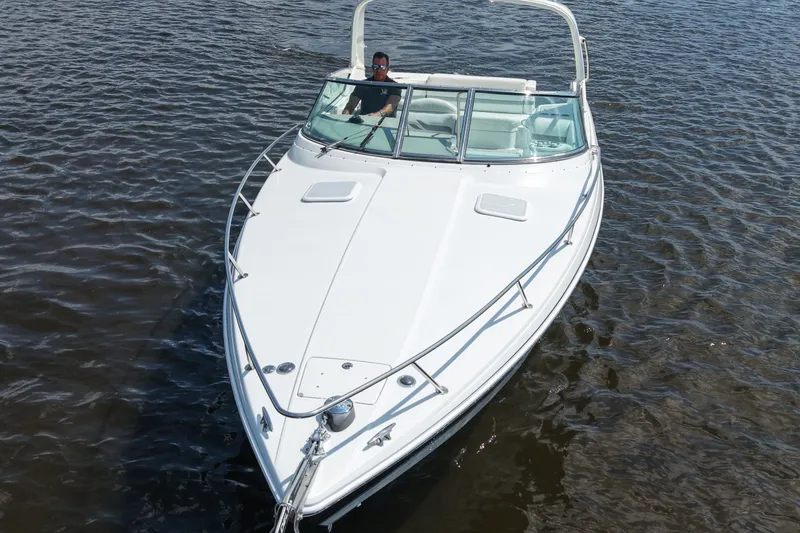 Slide: The Image of 2004 Formula 330 Sun Sport boat cruising on water, featuring sleek white design. - 10