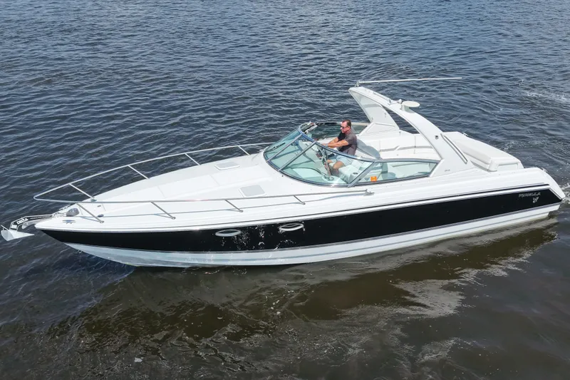 Slide: The Image of 2004 Formula 330 Sun Sport boat cruising on open water, featuring sleek design and modern amenities. - 9