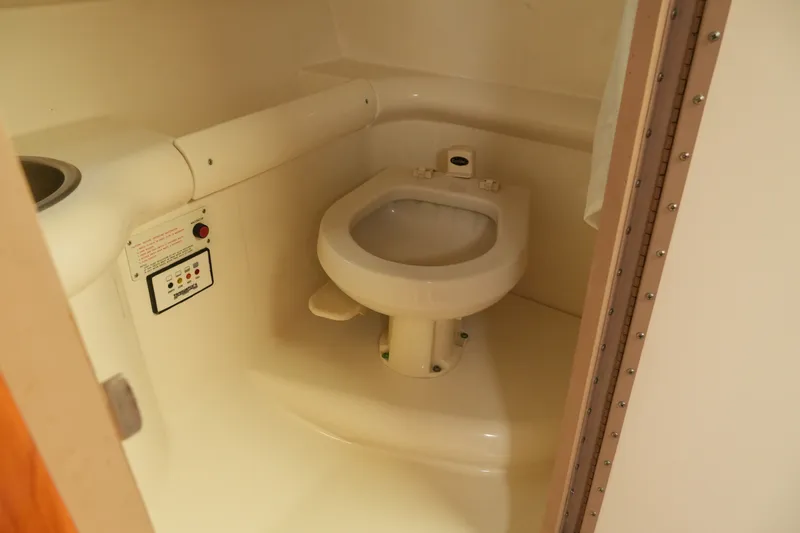 Slide: The Image of 2004 Formula 330 Sun Sport boat bathroom with compact toilet and control panel. - 39