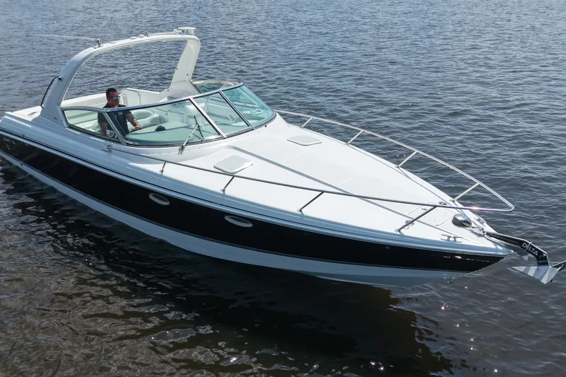 Slide: The Image of 2004 Formula 330 Sun Sport boat cruising on calm water. - 11