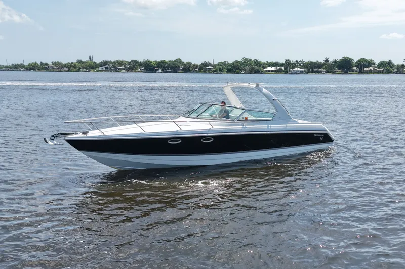 The Image of 2004 Formula 330 Sun Sport boat cruising on a sunny day in calm waters. - 3