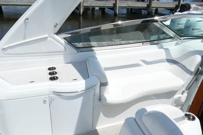 Slide: The Image of 2004 Formula 330 Sun Sport boat interior with white seating and cup holders. - 31