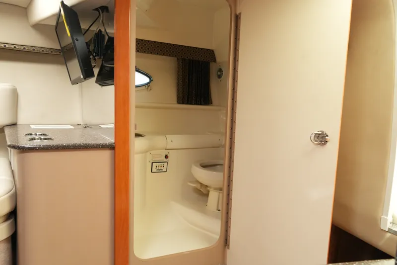 Slide: The Image of Interior of 2004 Formula 330 Sun Sport boat showing compact bathroom and seating area. - 41