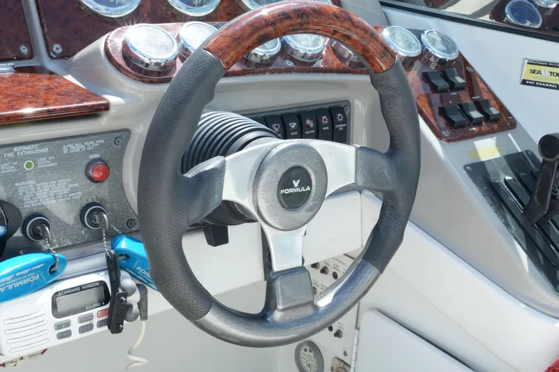 Slide: The Image of Steering wheel and dashboard of a 2004 Formula 330 Sun Sport boat. - 24