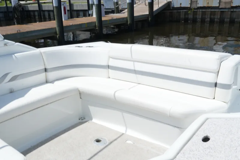 Slide: The Image of 2004 Formula 330 Sun Sport boat interior with white seating at dock. - 16