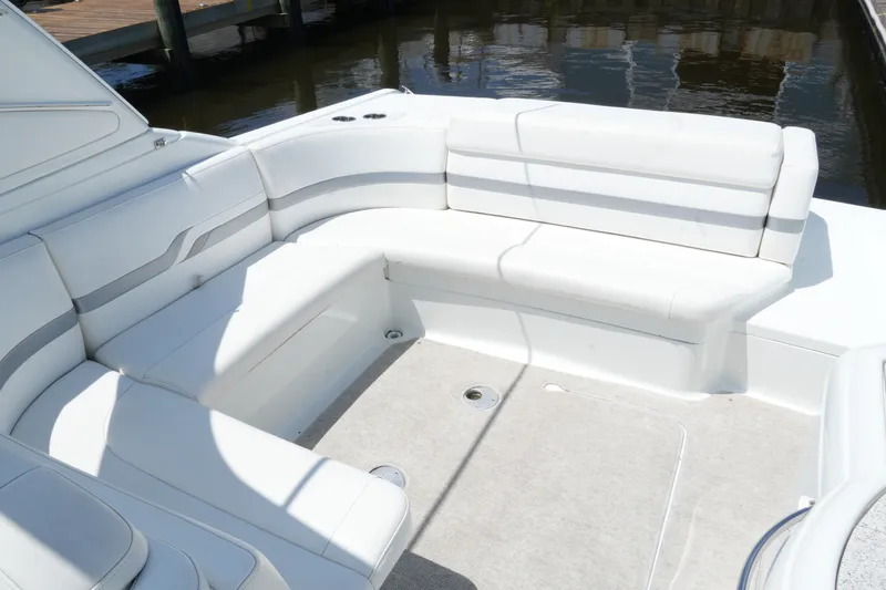 Slide: The Image of 2004 Formula 330 Sun Sport boat with white cushioned seating and spacious deck area. - 30