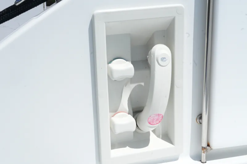 Slide: The Image of 2004 Formula 330 Sun Sport boat handle and controls in white compartment. - 15