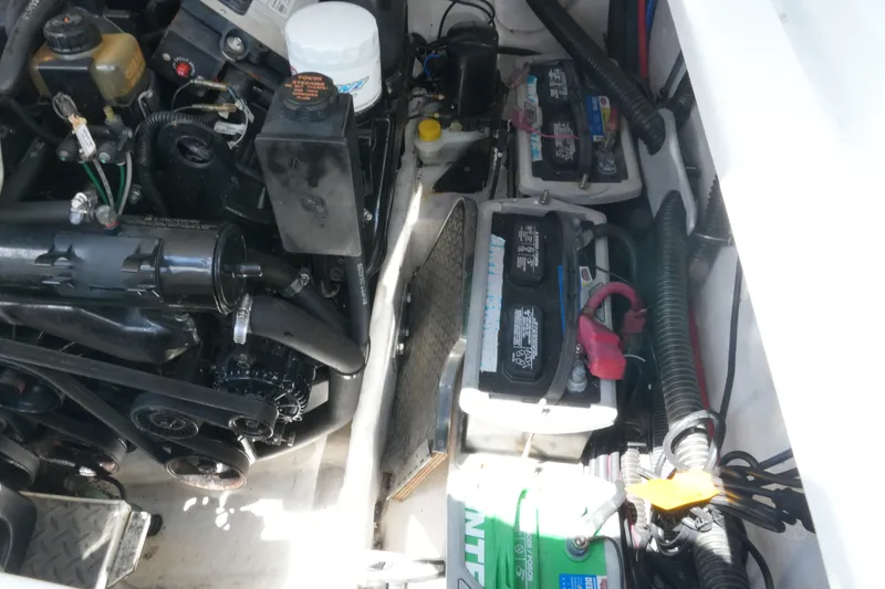 Slide: The Image of Engine compartment of a 2004 Formula 330 Sun Sport boat, showing batteries and mechanical components. - 44