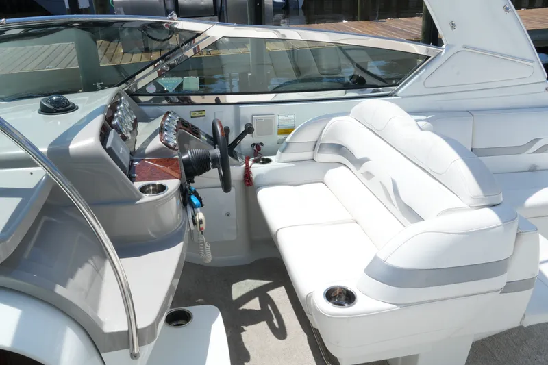 Slide: The Image of 2004 Formula 330 Sun Sport boat interior with white seating and modern dashboard. - 32