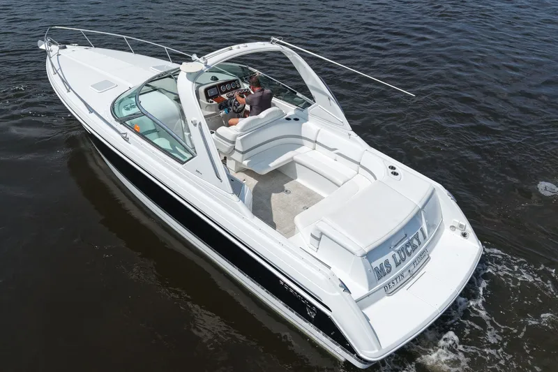 Slide: The Image of 2004 Formula 330 Sun Sport boat cruising on water, featuring sleek white design and spacious seating. - 8