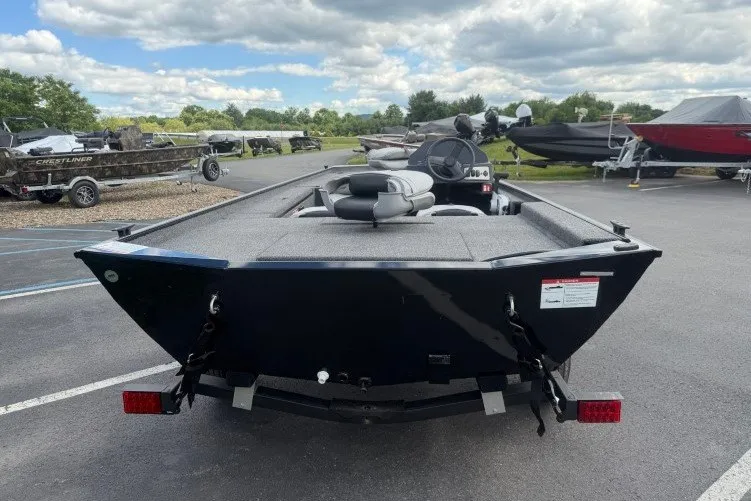 Slide: The Image of 2026 Crestliner 1600 Storm boat in parking lot, showcasing sleek design and spacious interior. - 16