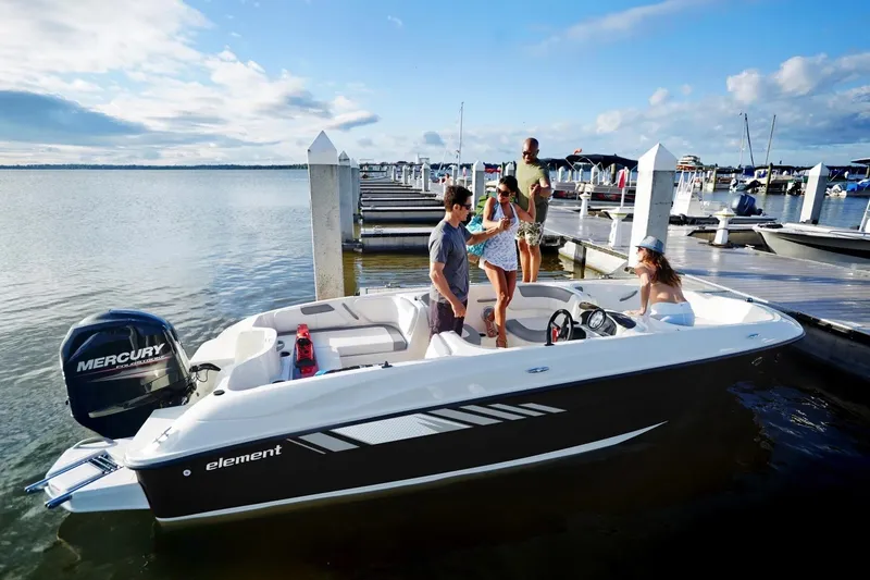 Slide: The Image of 2027 Bayliner Element E18 boat docked with people enjoying a sunny day. - 6