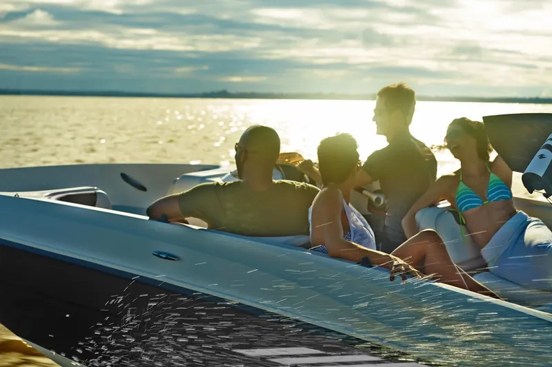 Slide: The Image of People enjoying a sunset cruise on a 2027 Bayliner Element E18 boat. - 4