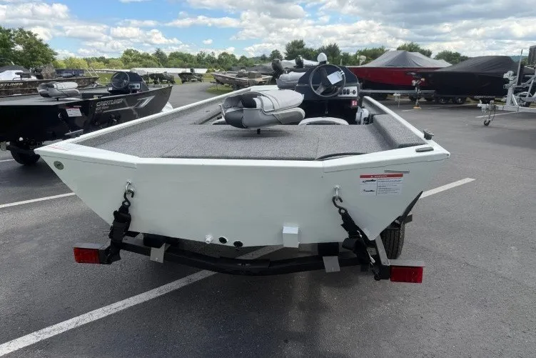 Slide: The Image of 2026 Crestliner 1600 Storm boat on trailer in parking lot, under cloudy sky. - 15