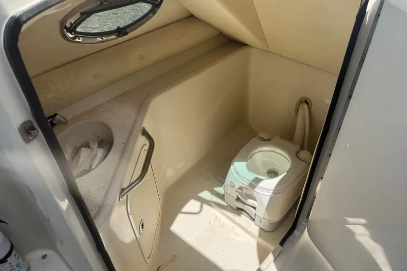 Slide: The Image of Interior of a 2006 Sea Ray 240 Sundeck boat with a compact marine toilet. - 13