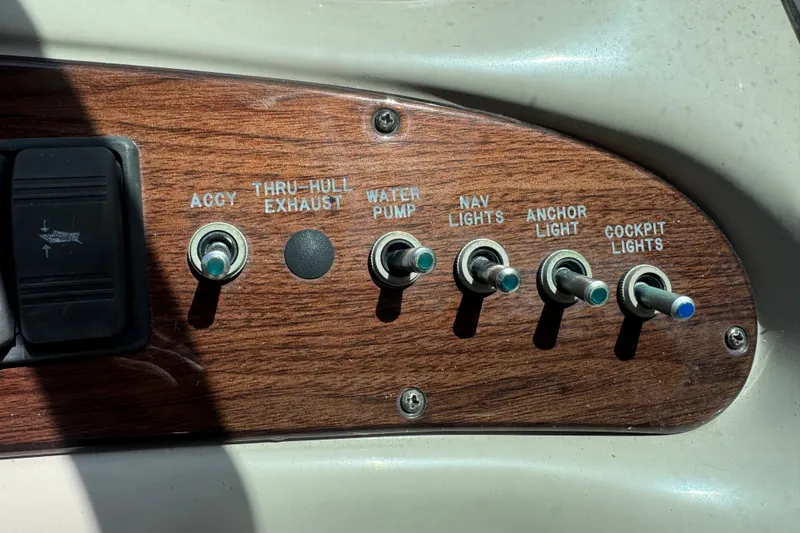 Slide: The Image of Control panel of a 2006 Sea Ray 240 Sundeck boat with labeled switches. - 22