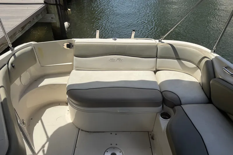 Slide: The Image of 2006 Sea Ray 240 Sundeck boat interior with cushioned seating by the water. - 33