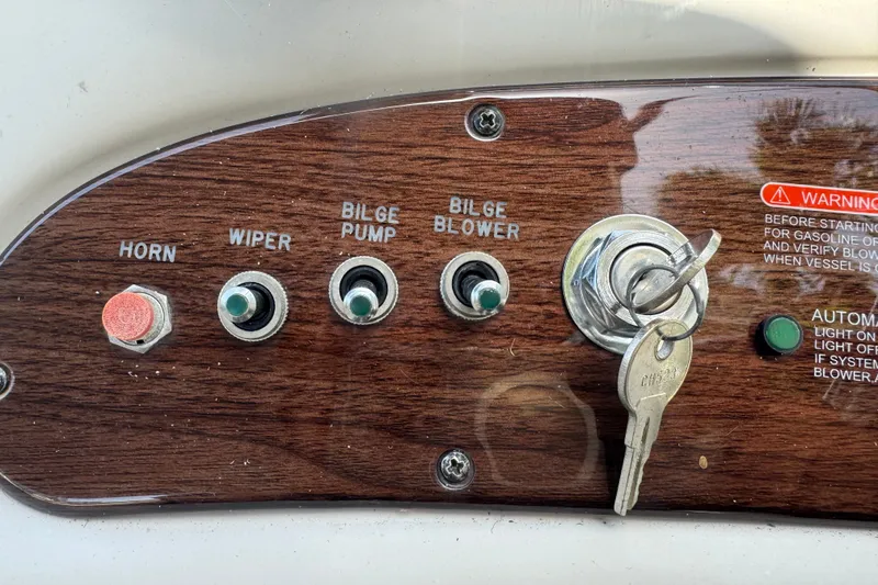Slide: The Image of Control panel of a 2006 Sea Ray 240 Sundeck with ignition keys and switches. - 23
