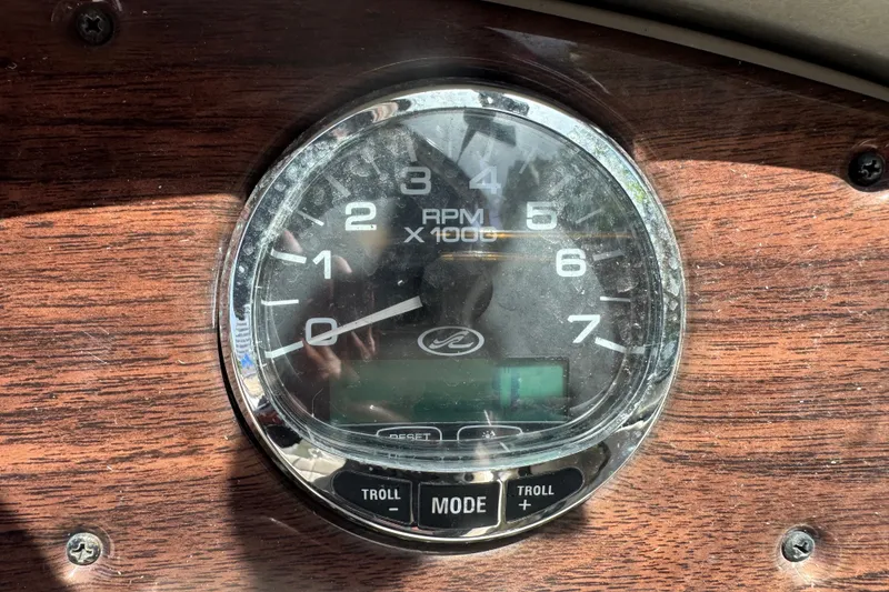 Slide: The Image of Tachometer of 2006 Sea Ray 240 Sundeck boat on wooden dashboard. - 21