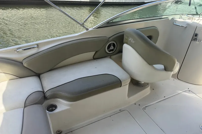 Slide: The Image of 2006 Sea Ray 240 Sundeck interior with beige seating and water view. - 26
