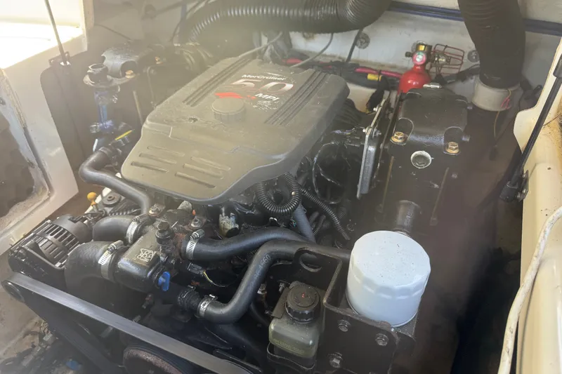 Slide: The Image of Engine compartment of a 2006 Sea Ray 240 Sundeck boat, featuring a MerCruiser engine. - 35