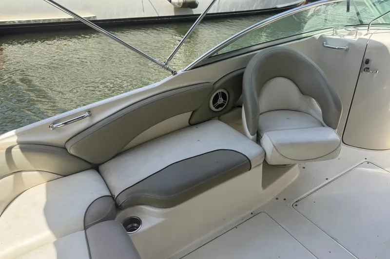 Slide: The Image of Interior seating of a 2006 Sea Ray 240 Sundeck boat, featuring cushioned seats. - 27