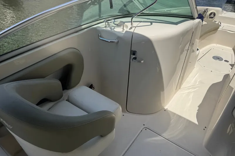 Slide: The Image of 2006 Sea Ray 240 Sundeck interior with seating and cup holders, showcasing sleek design. - 15