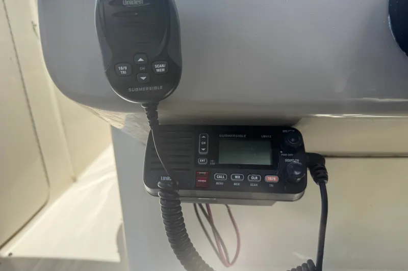 Slide: The Image of VHF radio system on a 2006 Sea Ray 240 Sundeck boat dashboard. - 17