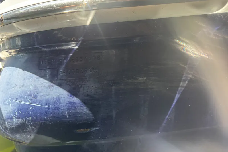 Slide: The Image of Close-up of 2006 Sea Ray 240 Sundeck hull with visible identification numbers. - 37