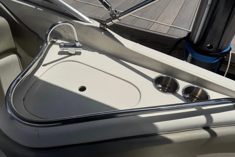 Slide: The Image of 2006 Sea Ray 240 Sundeck sink and cup holders on deck. - 29