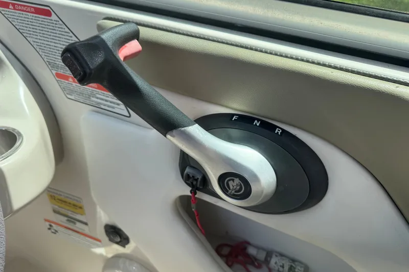 Slide: The Image of Throttle control lever on a 2006 Sea Ray 240 Sundeck boat dashboard. - 16