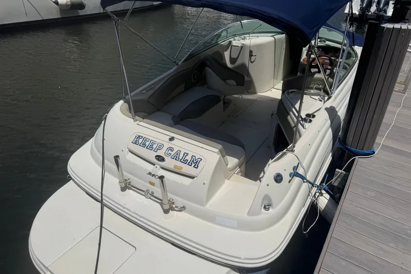 The Image of 2006 Sea Ray 240 Sundeck boat docked, featuring "Keep Calm" text on the stern. - 0