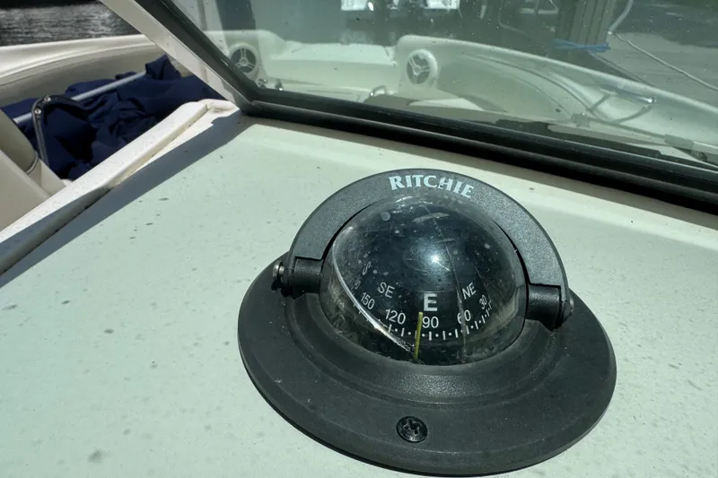 Slide: The Image of Compass on 2006 Sea Ray 240 Sundeck boat dashboard, showing east direction. - 18