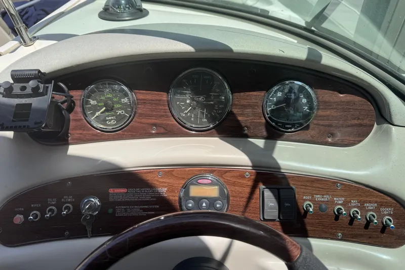 Slide: The Image of Dashboard of a 2006 Sea Ray 240 Sundeck boat with gauges and controls. - 24