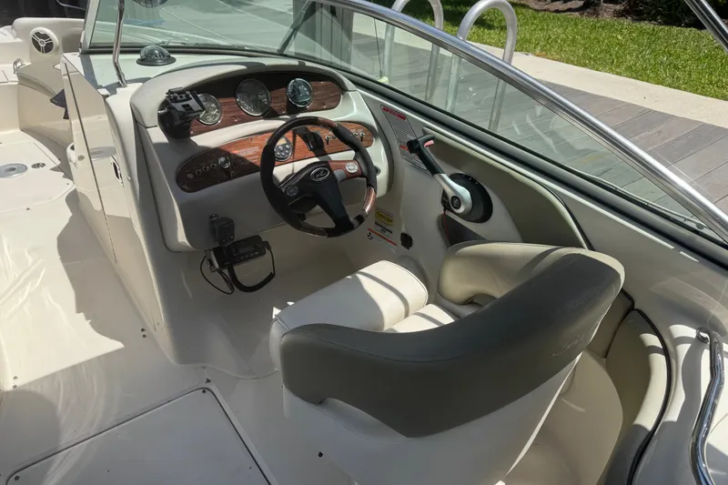 Slide: The Image of Interior view of 2006 Sea Ray 240 Sundeck boat cockpit with steering wheel and controls. - 25