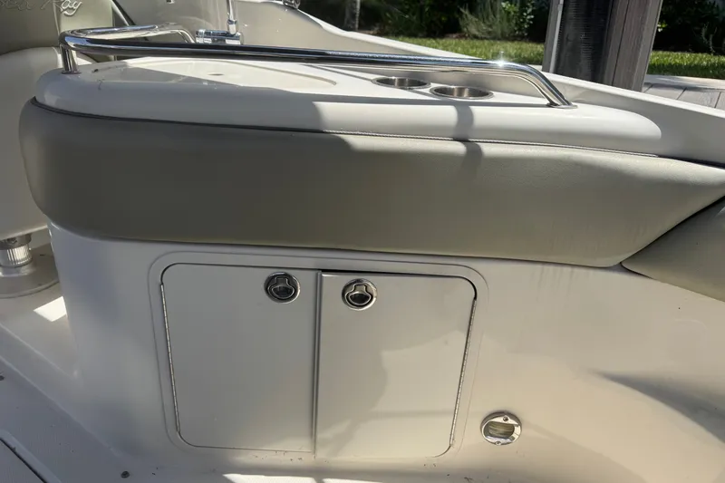 Slide: The Image of 2006 Sea Ray 240 Sundeck boat interior with storage compartment and cup holders. - 32