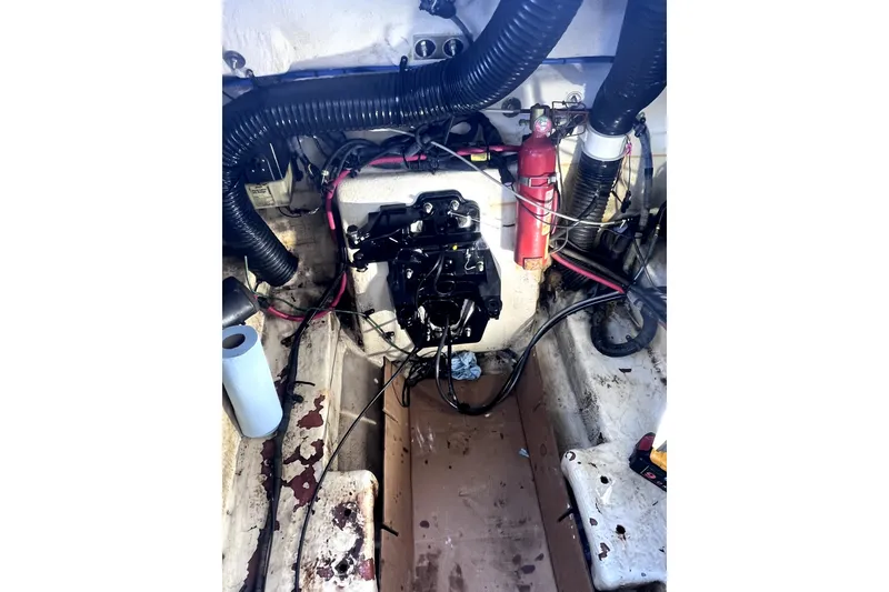 Slide: The Image of Engine compartment of a 2006 Sea Ray 240 Sundeck with visible wiring and components. - 39