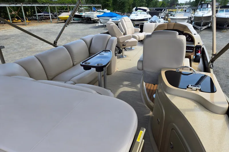 Slide: The Image of Interior of a 2013 Sanpan 2500 FE pontoon boat with beige seating and helm. - 21