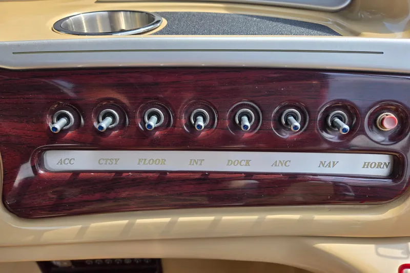 Slide: The Image of Control panel of a 2013 Sanpan 2500 FE boat with labeled switches. - 36