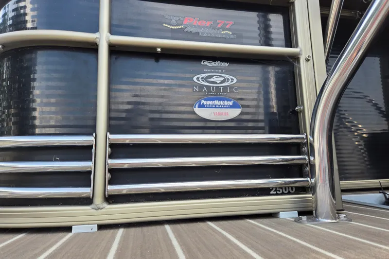Slide: The Image of 2013 Sanpan 2500 FE pontoon boat with chrome railings and brand logos. - 5