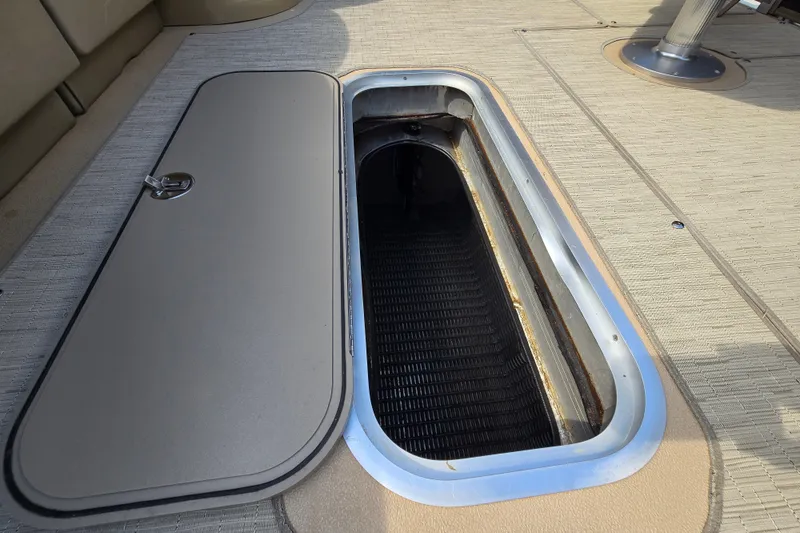 Slide: The Image of Open storage compartment on 2013 Sanpan 2500 FE boat deck. - 52