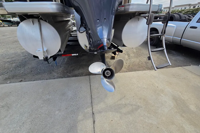 Slide: The Image of Rear view of a 2013 Sanpan 2500 FE pontoon boat with visible propeller and ladder. - 10