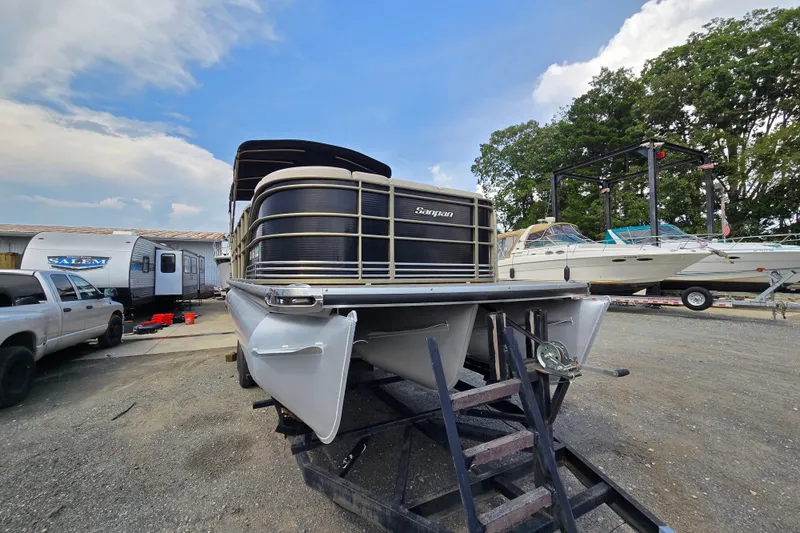 Slide: The Image of 2013 Sanpan 2500 FE pontoon boat on trailer in outdoor storage area. - 3