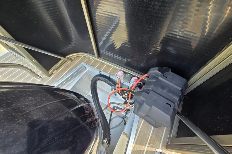 Slide: The Image of Battery compartment of a 2013 Sanpan 2500 FE boat with wiring and components. - 50